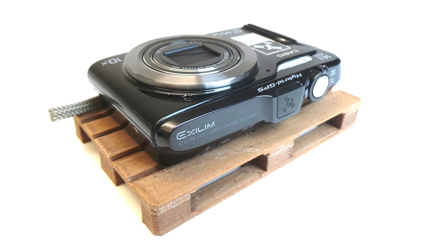 a small camera is displayed on top of a crate