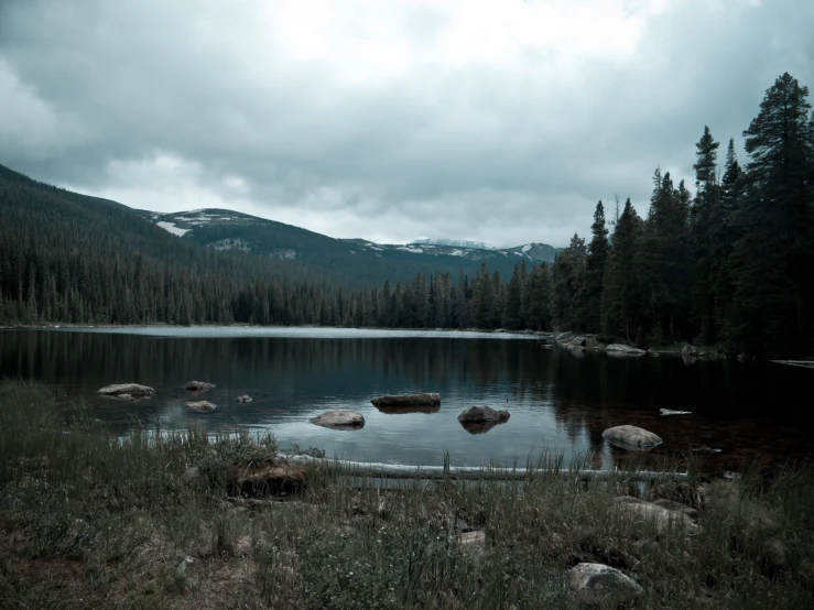 the calm waters and mountains are reflected in the water