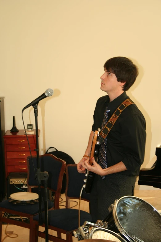 a man with a guitar while he is singing