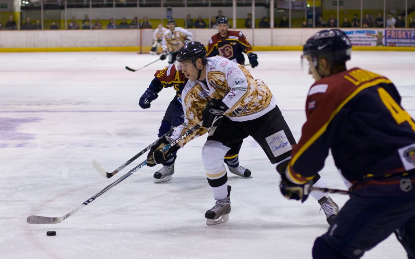 several ice hockey players playing on a rink