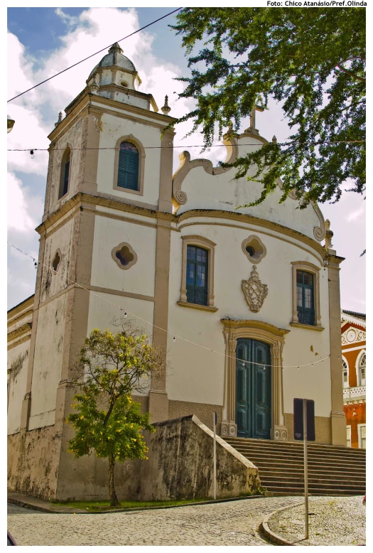 a church with two large windows and a clock on it