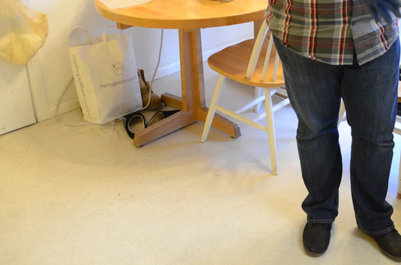 woman holding a cat in front of a table