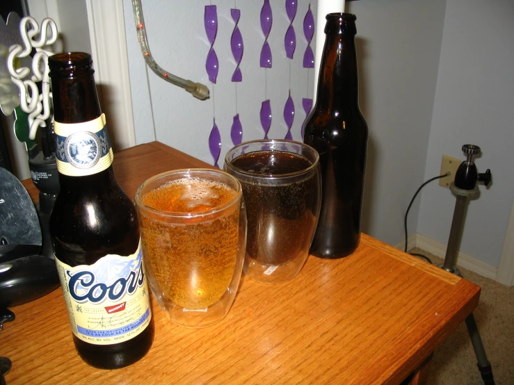 bottles, glasses and a can on a table