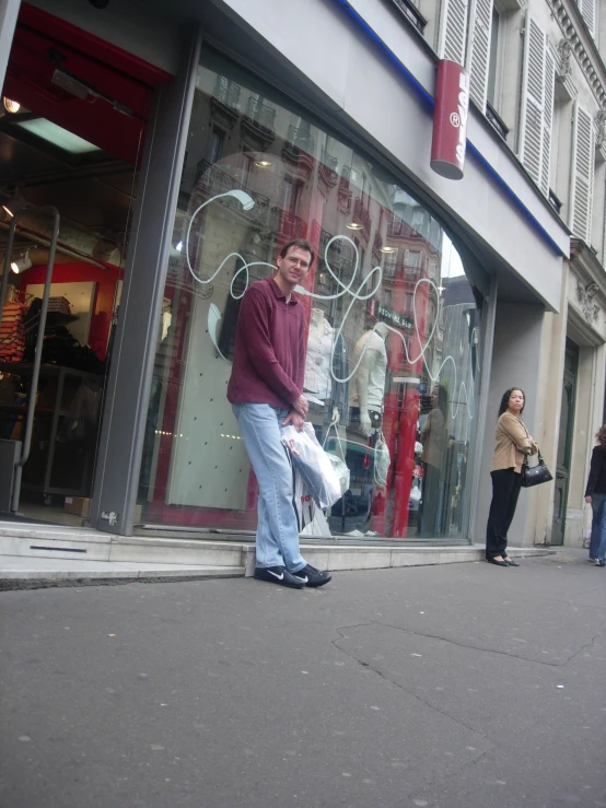 a man is standing outside of a store