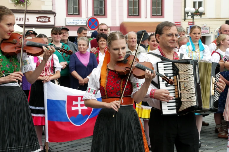 musicians performing in front of some people with flags