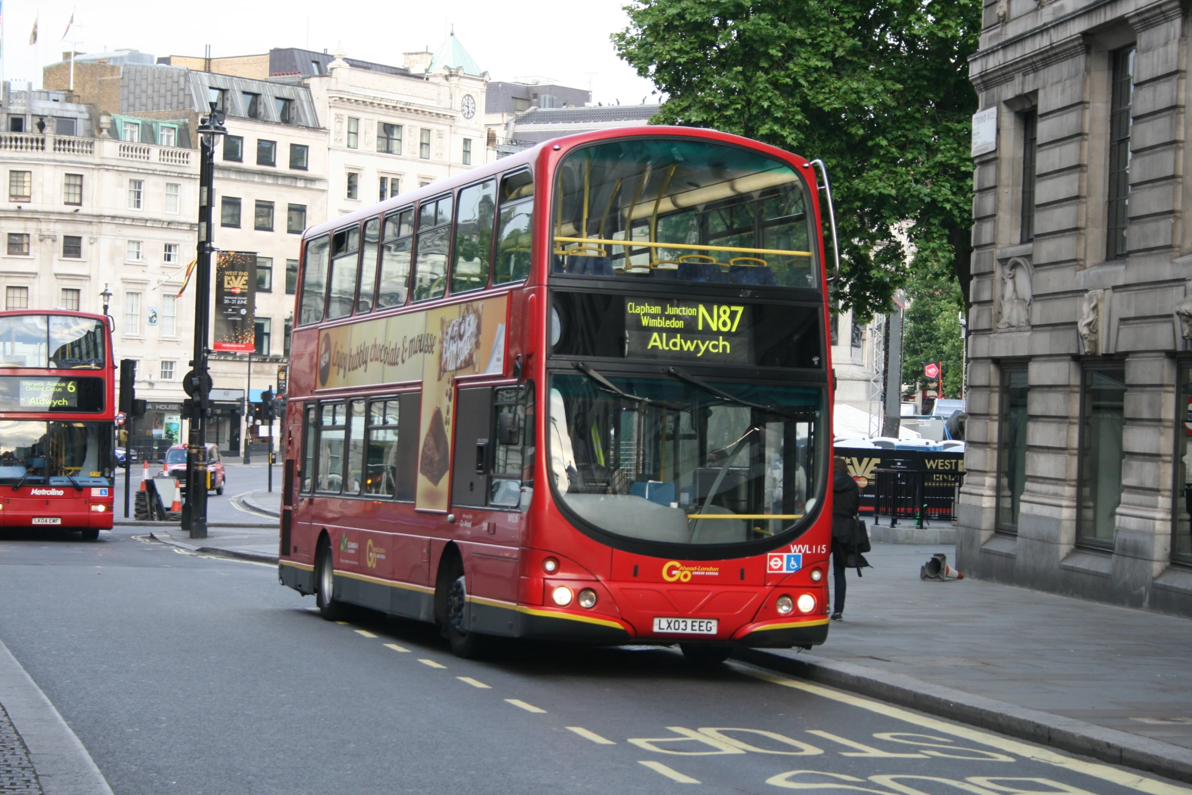 two double decker buses on a city street