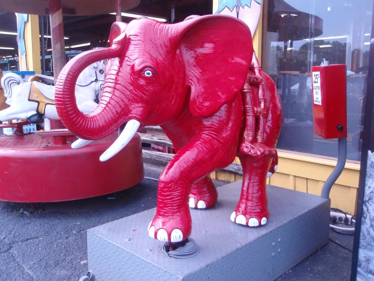 a statue of an elephant is displayed in front of a store