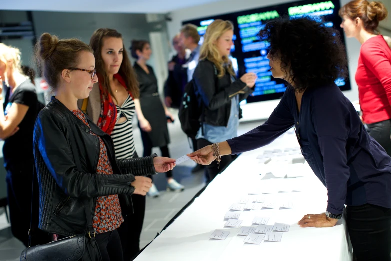 a woman reaching out to touch some type of paper