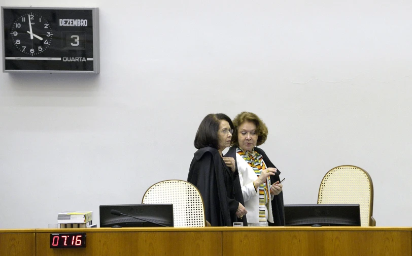 two woman are talking in front of a judge