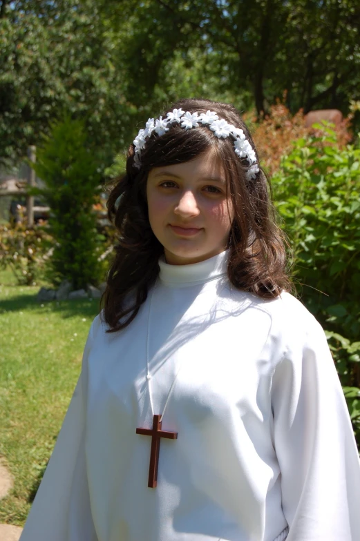 a  wearing a catholic cross necklace