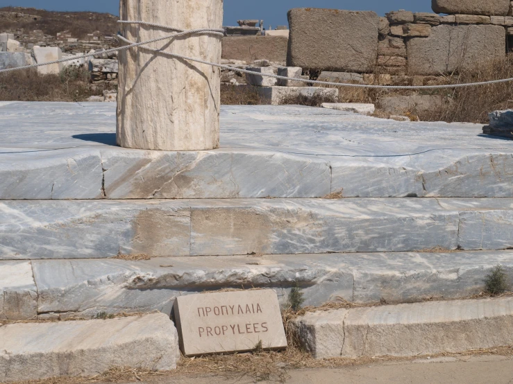 an inscription on rocks and stones near two stone pillars