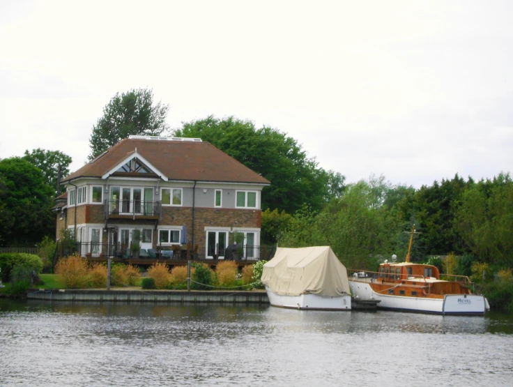 two small boats tied up to the side of a large house