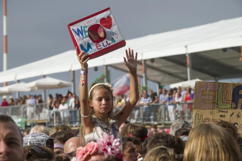 a  holds up a sign in a crowd