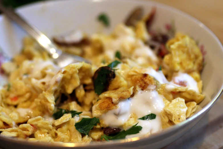 a bowl with a spoon full of food