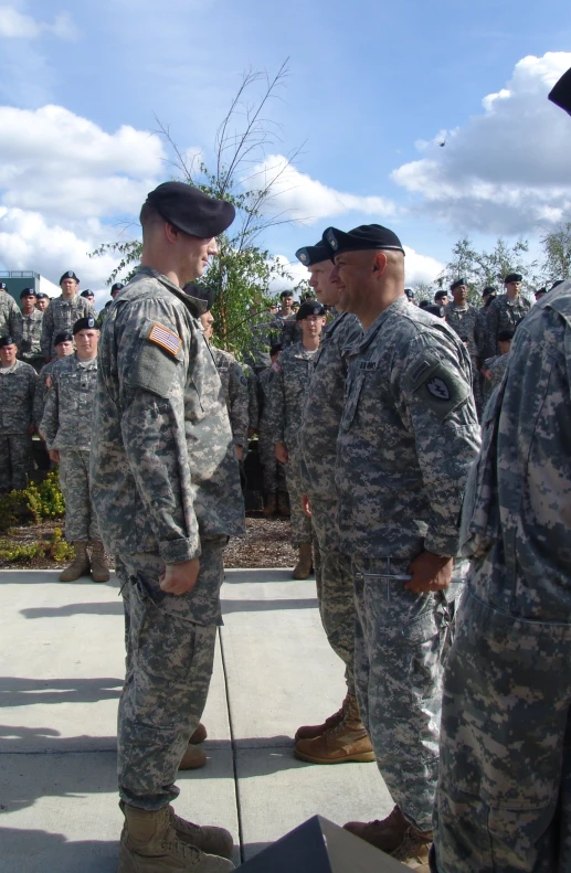 a group of military men standing around each other