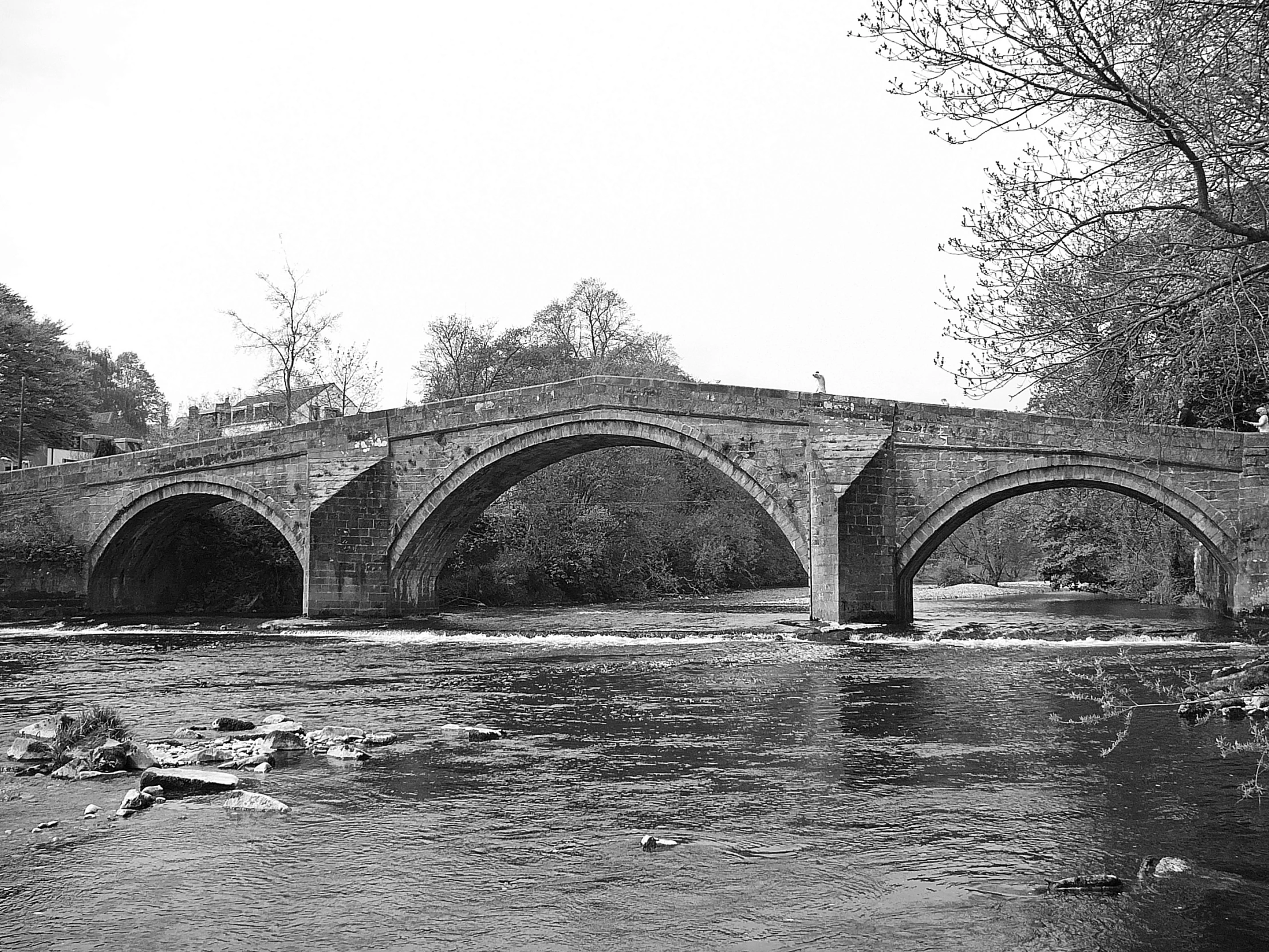 a black and white po of a stone bridge