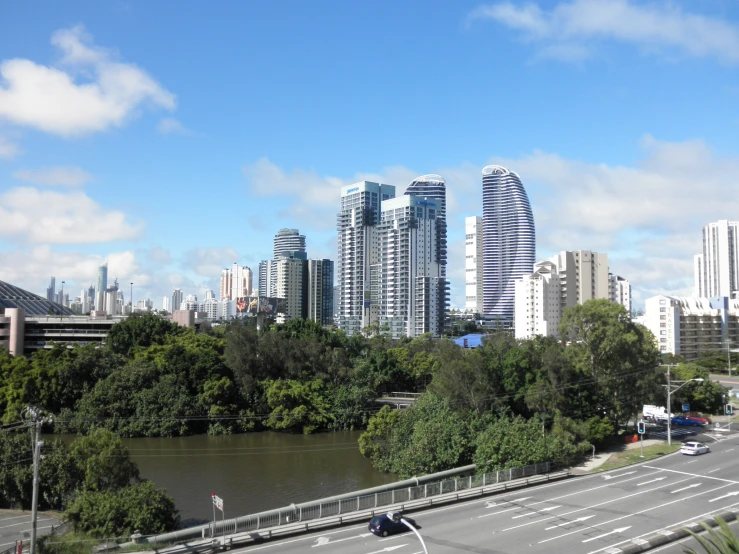 a view of a city with trees, roads, and cars