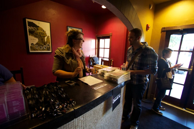 people standing around the counter talking and drinking