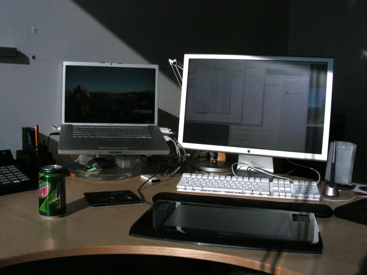 a home computer on a desk with other electronics and gadgets