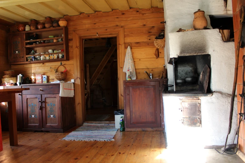 an old style kitchen and stove that are brown