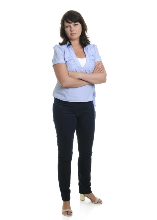 a woman in blue is standing and wearing black pants