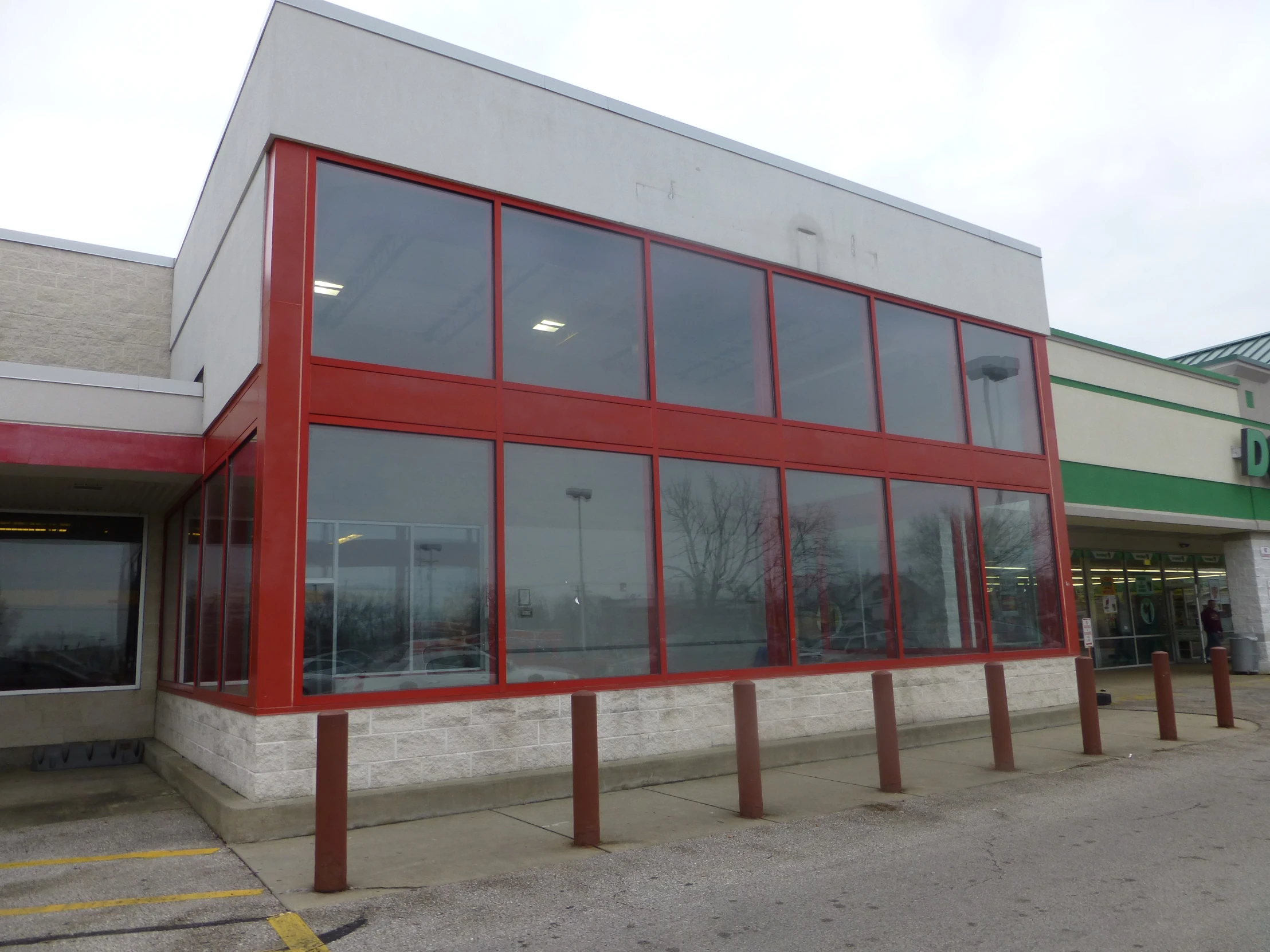 a large windowed store with lots of red bars