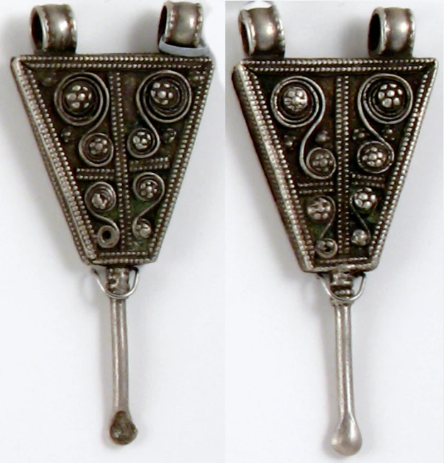 two silver vases on a white wall holding beads