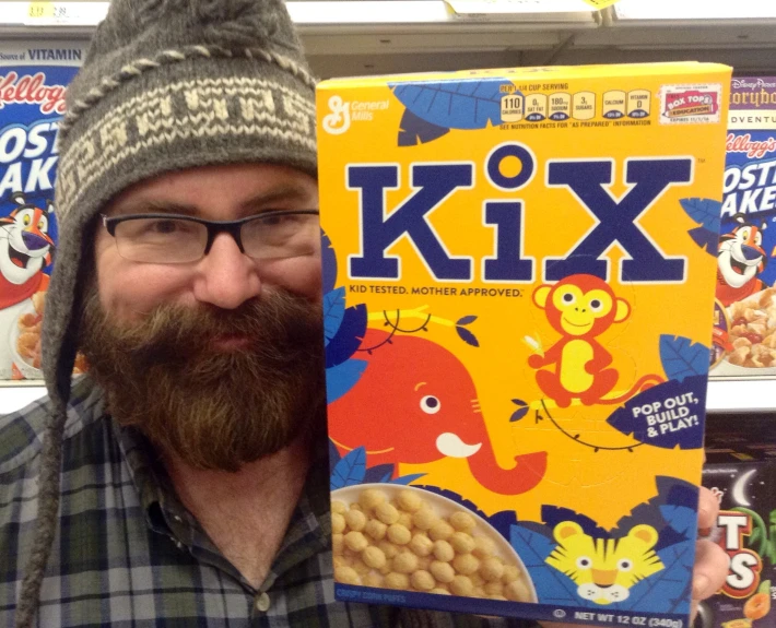 a man that is holding some cereal with a box