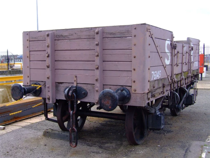 a purple train cart sitting next to a wooden box
