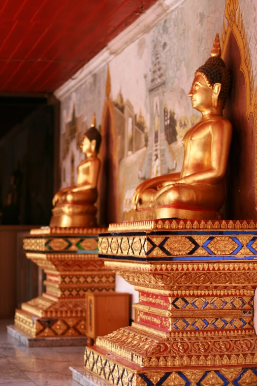 some statues and a wall hanging in a building