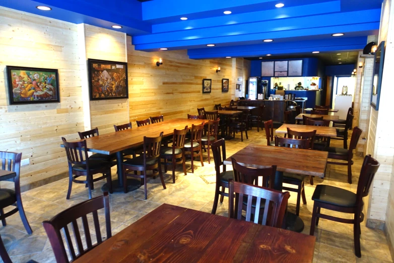 a large restaurant with wooden tables and chairs