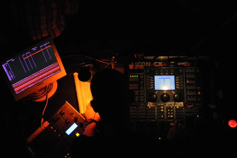 a sound mixing machine sits in the dark