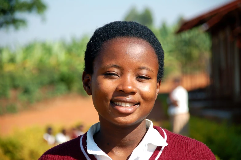 a girl in a red sweater and white shirt smiling