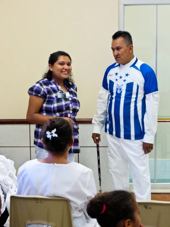 a man and woman in costumes standing near a group of people