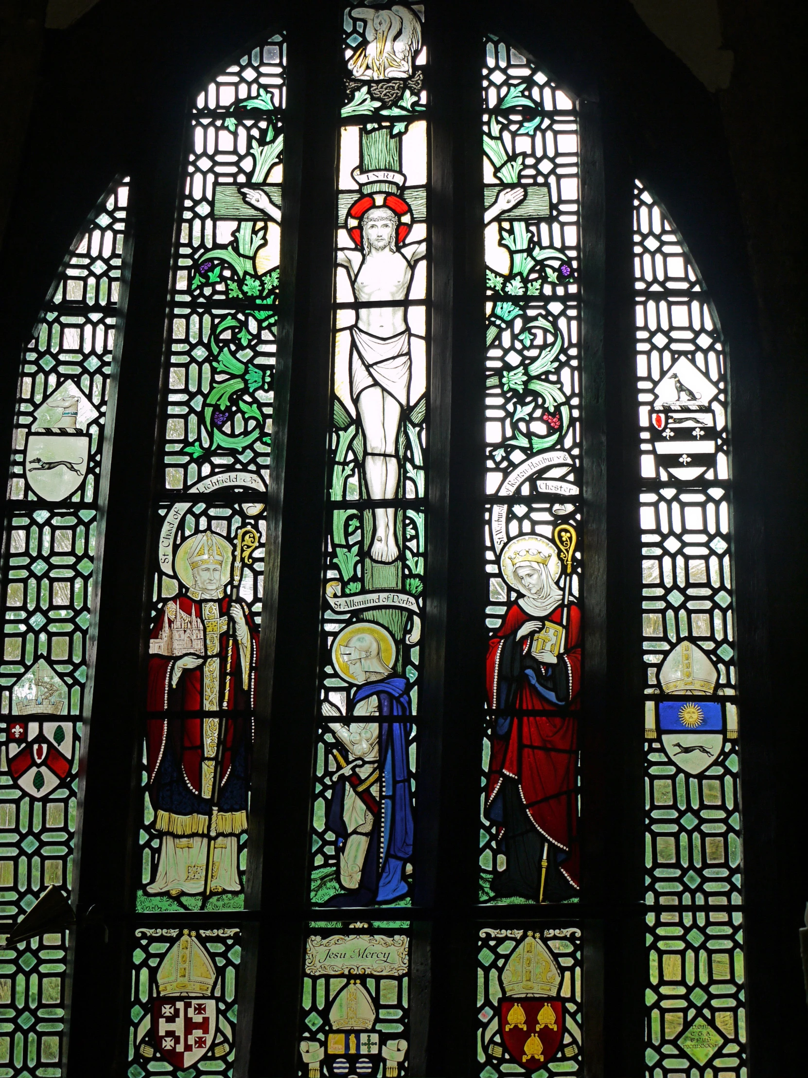 a stained glass window with several different paintings on it