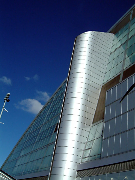 an unusual silver building with large windows on top