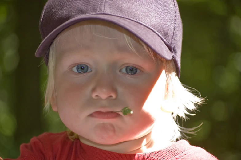 a young child with a frisbee in his mouth