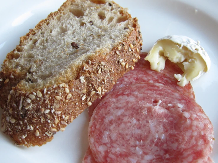 a plate filled with meat and bread on it