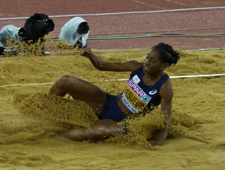 a woman falling off of a wrestling ring