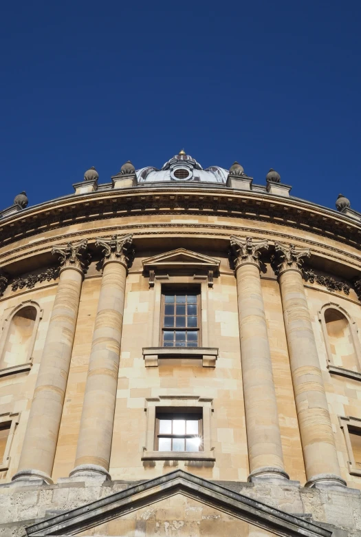 the top of a building with a blue sky background