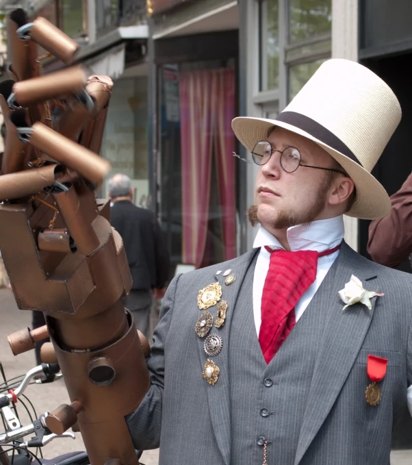 a man in a top hat and suit has metal items