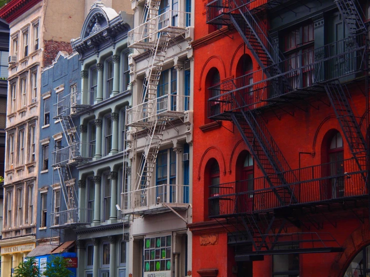 many buildings with fire escape stairs on each side