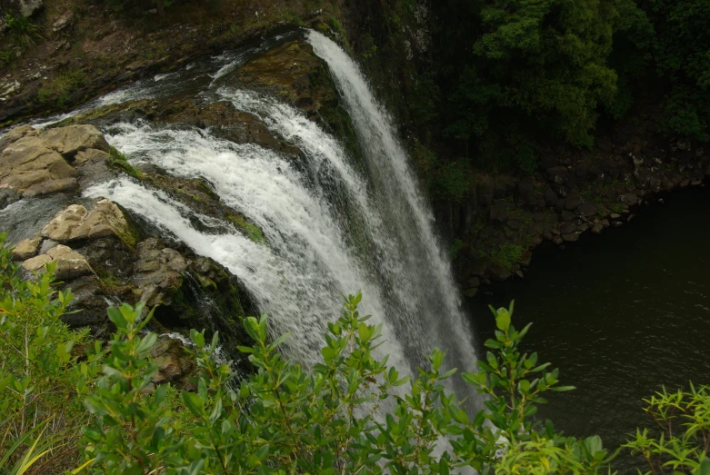 waterfall in the forest looking over to the water