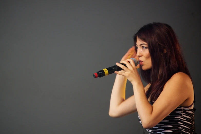 a woman standing in front of a microphone