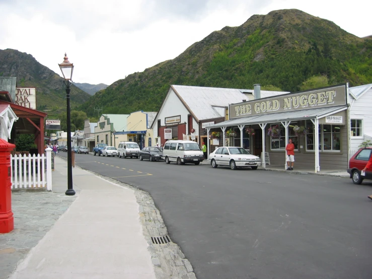 an image of town with cars parked on the side