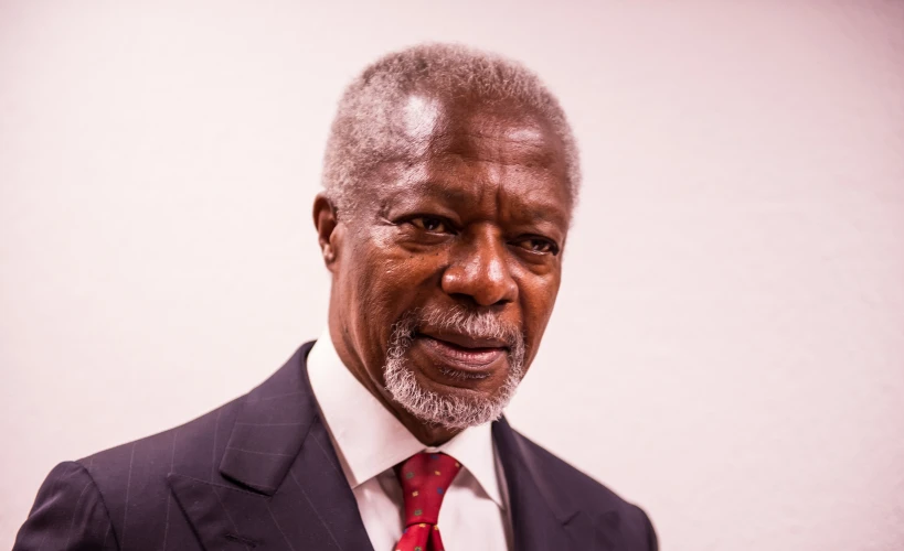 a man in a suit smiling for the camera