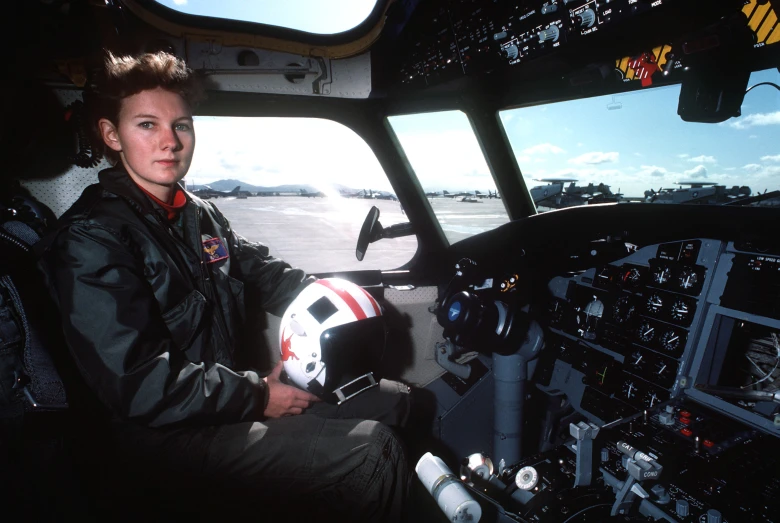 an older po of a woman pilot in the cockpit of a plane