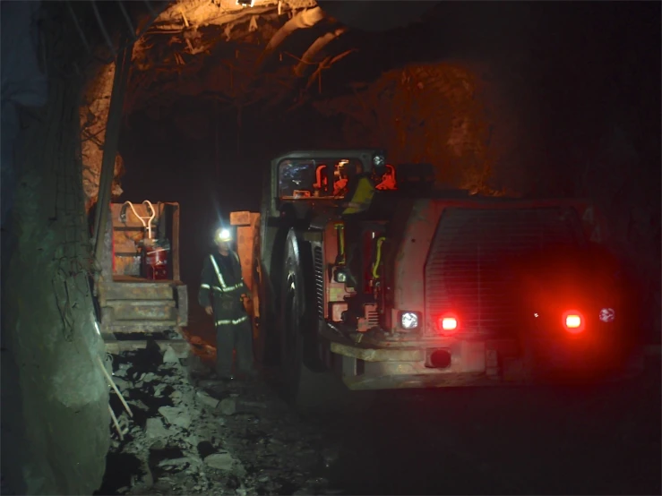 workers are in an underground tunnel with their equipment