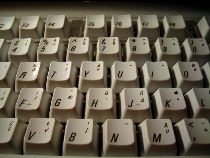 a white computer keyboard with several letters