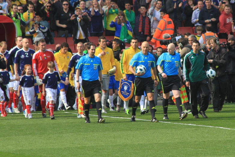 a group of men on a field playing soccer